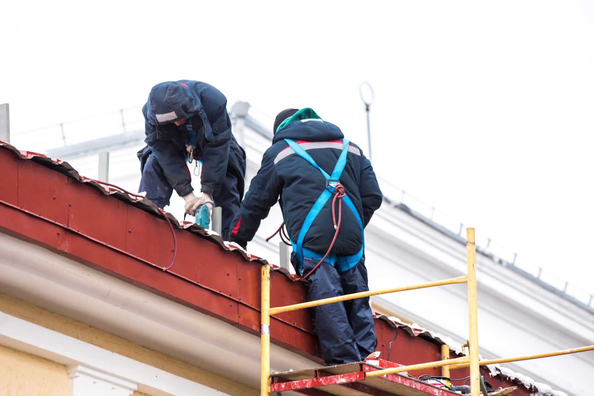 Two high altitude workers work