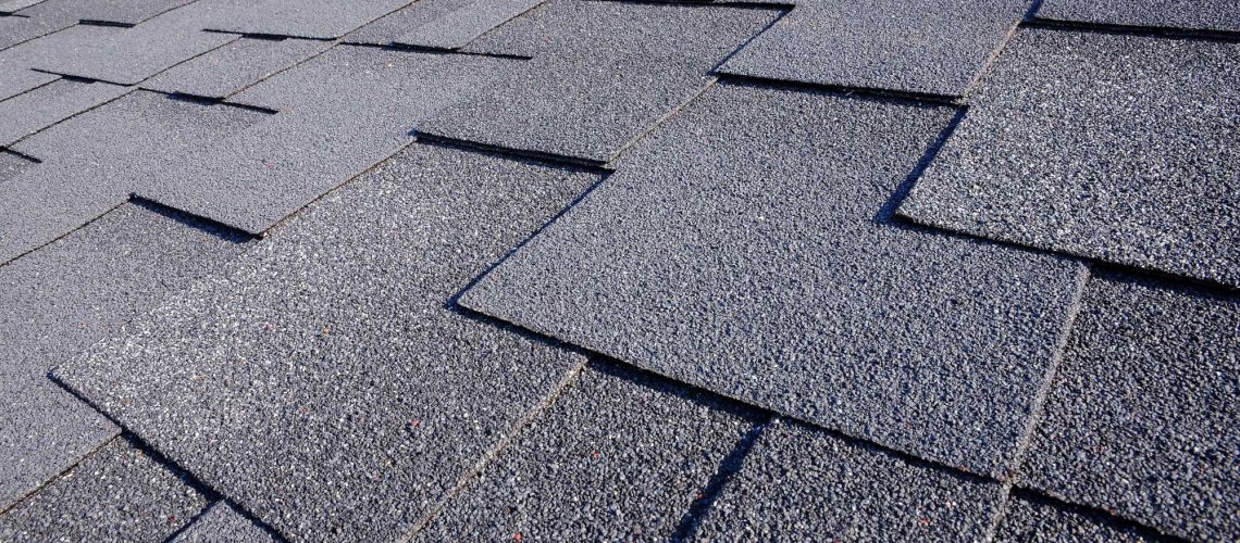 Close up view on Asphalt Roofing Shingles Background. Roof Shingles - Roofing.