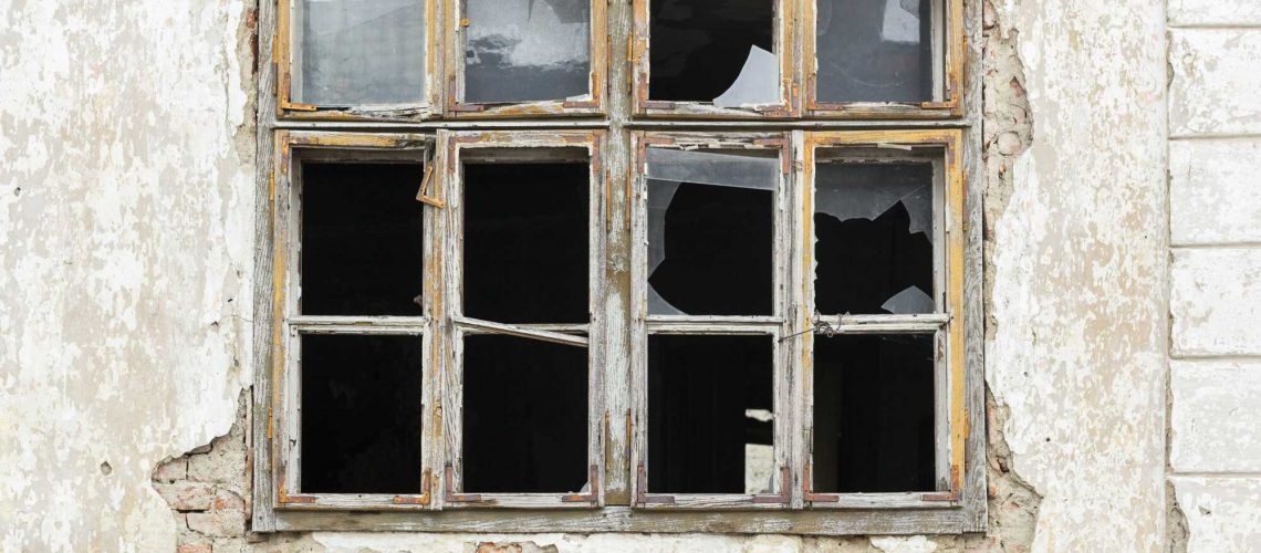 Old broken window on an abandoned old building